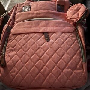Quilted Peach color to me  Backpack I think it has a changing pad in it.